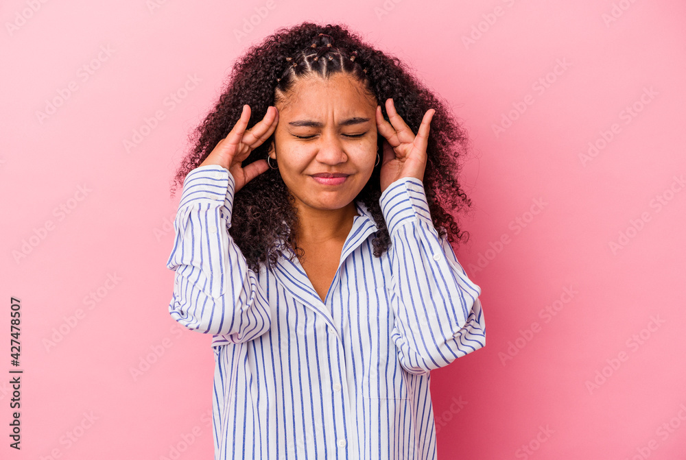 Young african american woman isolated on pink background touching temples and having headache. Young african american woman isolated on pink background touching temples and having headache.
