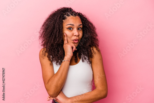 Young african american woman isolated on pink background having some great idea, concept of creativity.