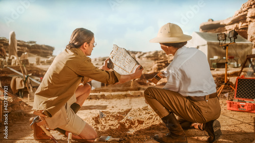 Archeological Digging Site: Two Great Archeologists Work on Excavation Site, Carefully Holding Newly Discovered Ancient Civilization Cultural Artifact, Historical Clay Tablet, Fossil Remains