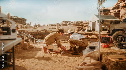 Tableau sur toile Archaeological Digging Site: Great Female Archeologist Work on Excavation Site,