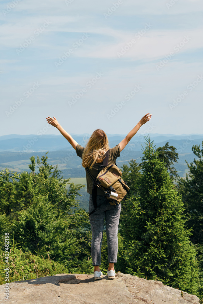 Girl enjoy scenics view on valley. Beautiful nature landscape in mountains. Hiking journey on tourist trail. Outdoor adventure. Travel and exploration. Healthy lifestyle, leisure activities