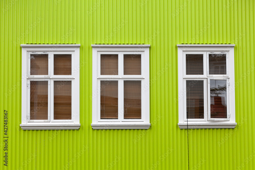 Fototapeta premium Windows on the bright green wall, Reykjavik, Iceland
