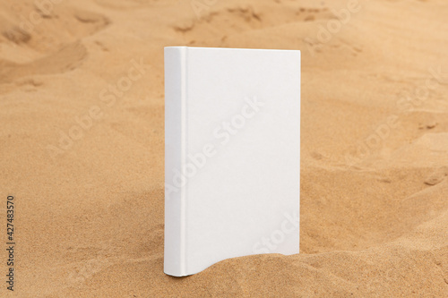 book with blank cover and empty cover perched on sandstone rock
