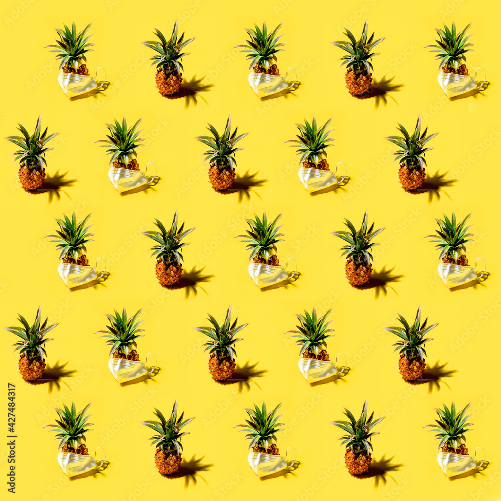 Fototapeta premium Many pineapples on a solid yellow background pattern