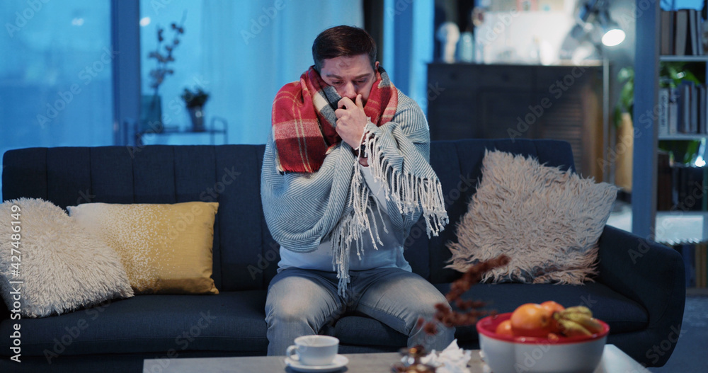 Caucasian Young Sick Adult Wearing Covering in Warm Blanket Recovering Illness Suffering Virus of Flu Staying Home Social Distancing. Influenza. Pandemic.