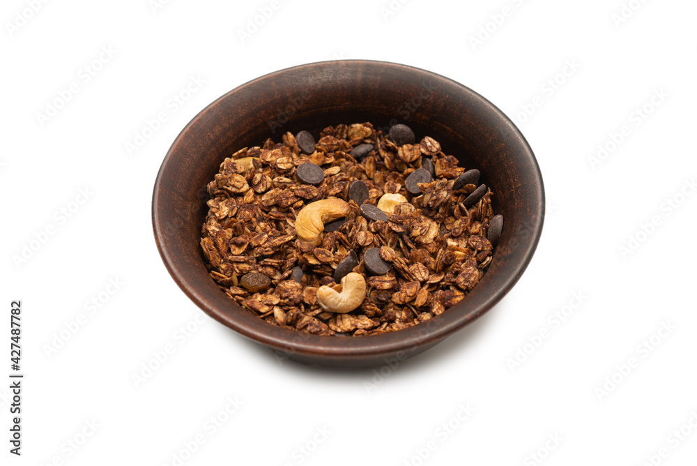 Chocolate granola cereal with nuts in a bowl background. Chocolate granola cereal with nuts in a bowl background.