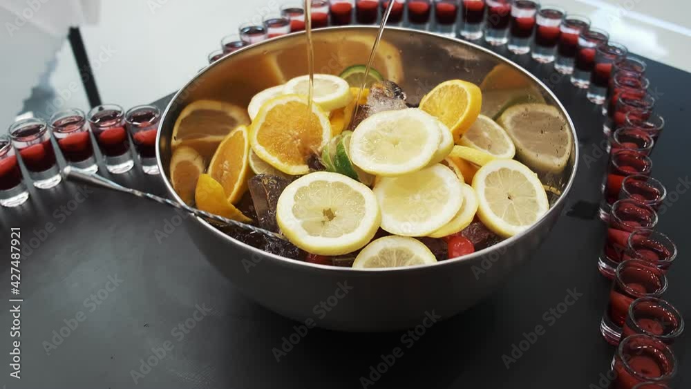 Mixed punch with fresh fruits in metal bowl Mixed punch with fresh fruits in metal bowl