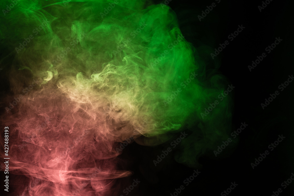 Green and pink steam on a black background. Green and pink steam on a black background.