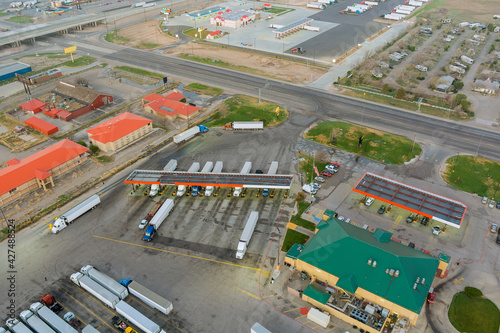 Drone view of the automotive large over road semi-trucks at fueling station