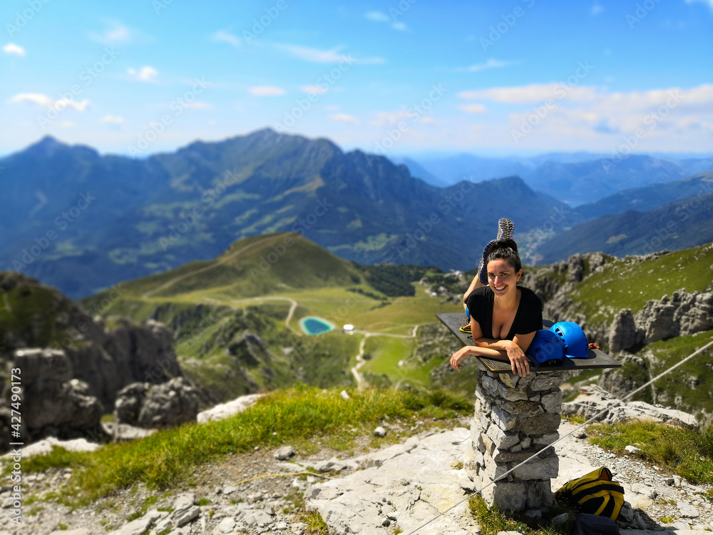 Young Woman looks at the stunning panorama after the climbing - Piani di Bobbio