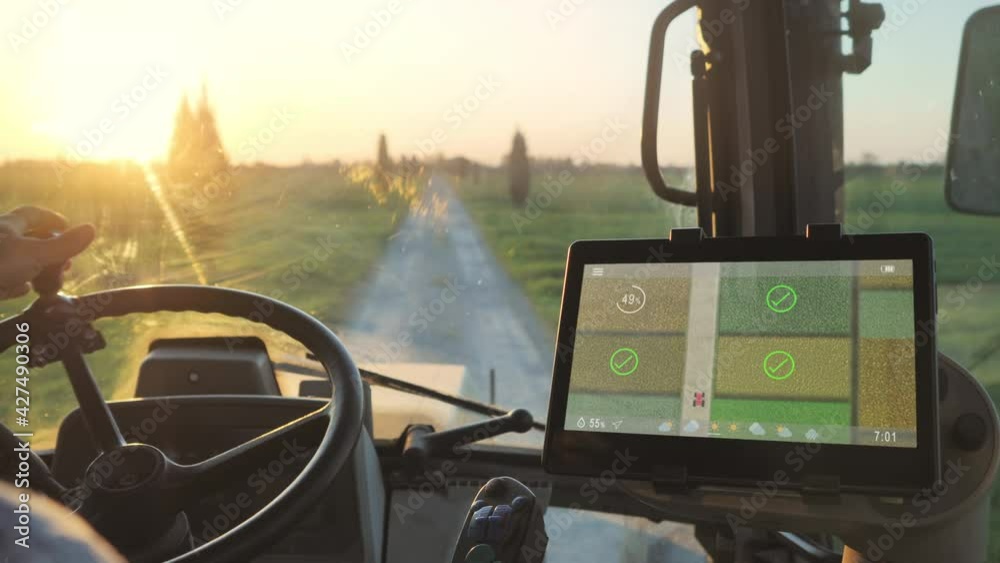 smart agriculture technology farmer using tablet application in the tractor cab to optimize the harvest,man driving tractor using touch screen display to check fields production condition