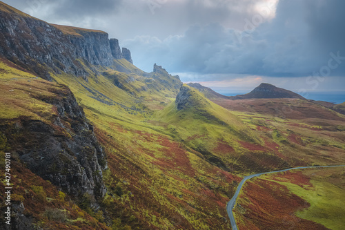 Moody, dramatic landscape view of the rugged, otherworldly terrain of the Quiraing on the Isle of Skye, Scotland.