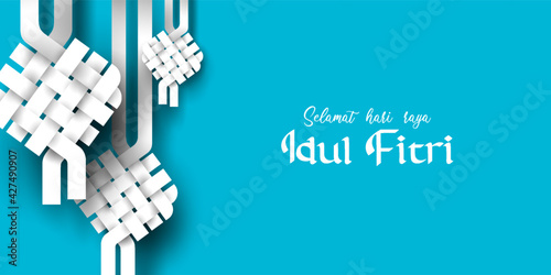 Selamat Idul Fitri with Ketupat ornament . Transalation text ; Happy Eid mubarak with paper cut style photo