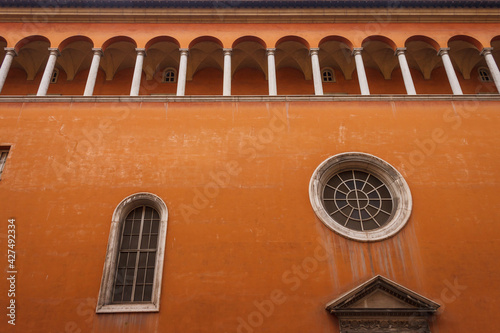 Old terracotta facade with arcade and windows. Italy. Rome photo