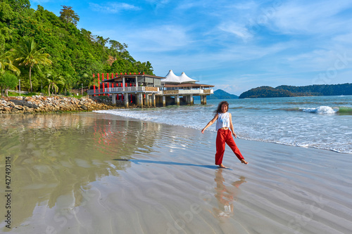 happy tourist woman enjoy travel on the central beach in Langkawi tropical island