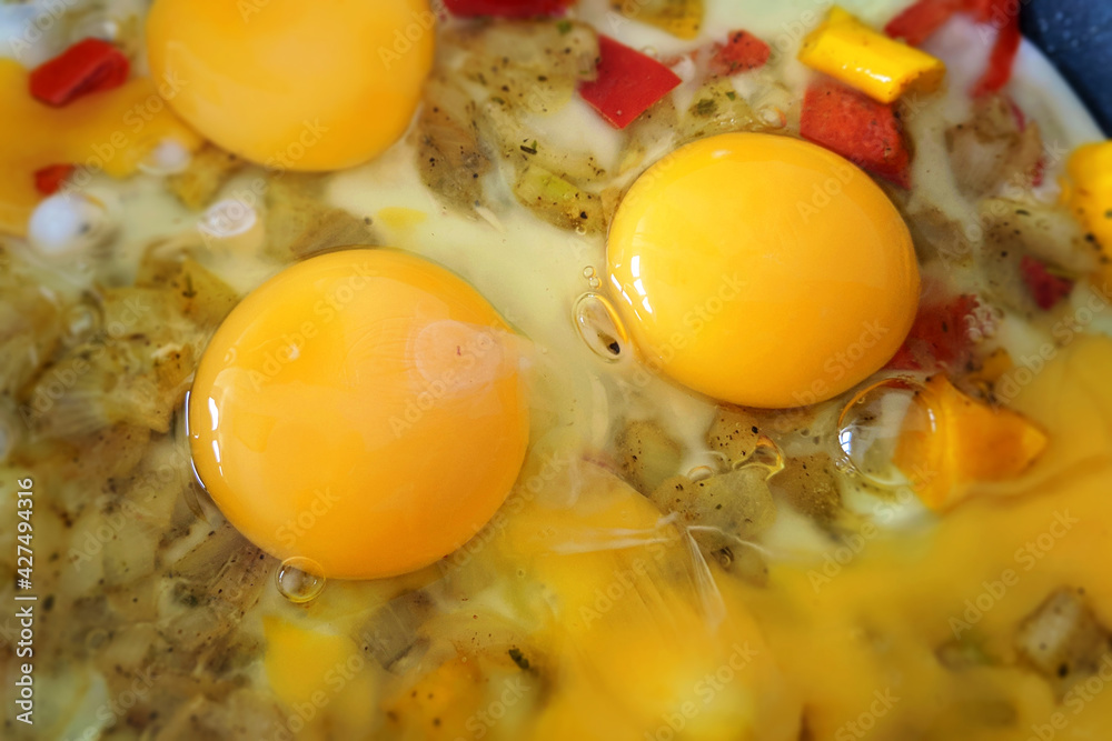 Scrambled eggs with vegetables close-up blurred background Scrambled eggs with vegetables close-up blurred background