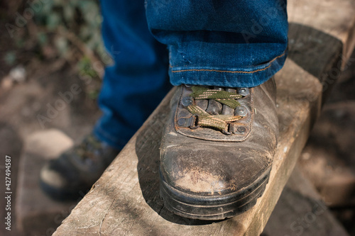 Hiking boot on a style in the countryside