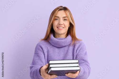 Woman with books on color b...