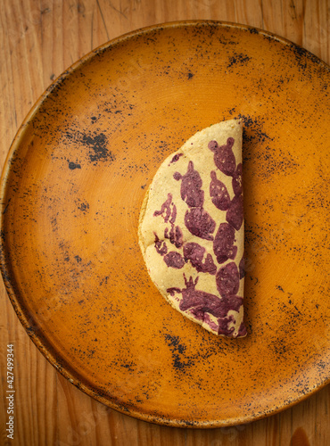 Taco mexicano con nopal pintado con grana cochinilla al estilo mazahua, relleno de frijoles negros, pepita de girasol y quelites photo