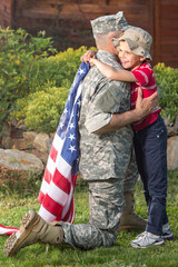 Happy reunion of soldier with family outdoors	