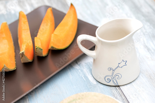Sliced orange melon on a wooden table