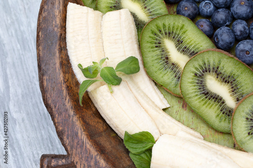 Fruits on plate. Wooden surface