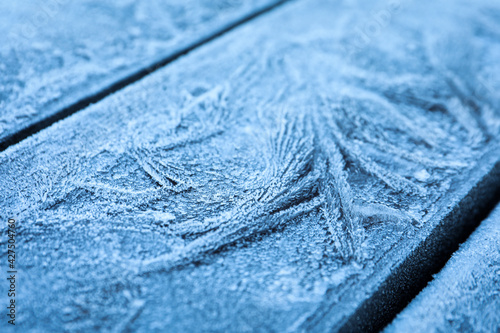 Beautiful hoarfrost on wooden surface, closeup view © New Africa