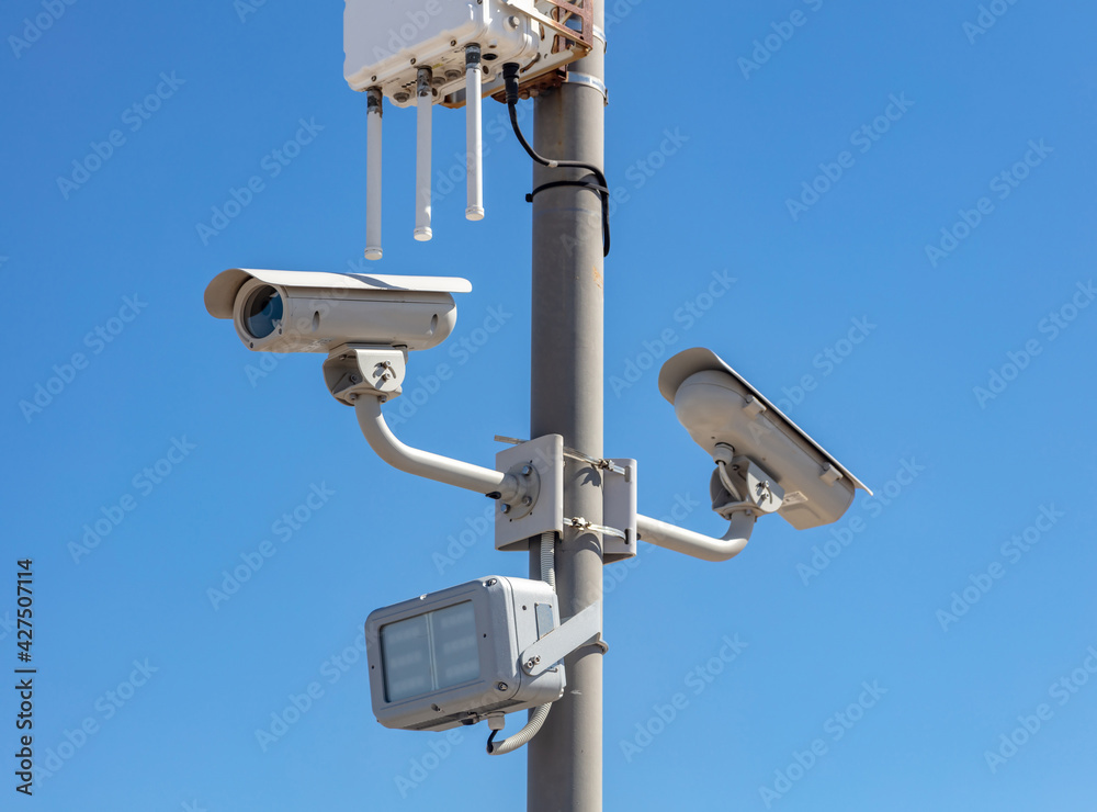 High resolution security cameras, blue sky background, copy space. High resolution security cameras, blue sky background, copy space.