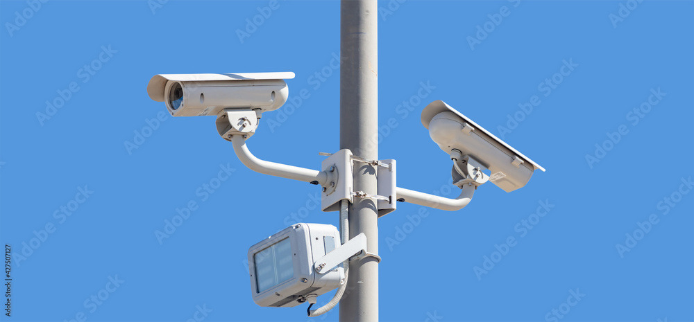 High resolution security cameras, blue sky background, copy space. High resolution security cameras, blue sky background, copy space.