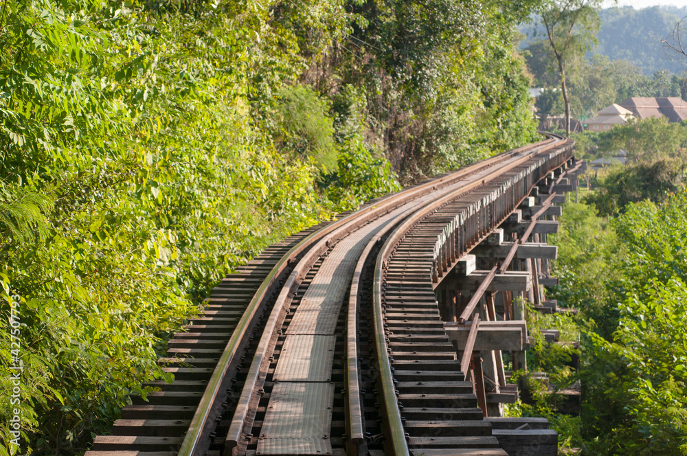 Part of the death railway, The railway train track runs along a hill through green forests and rivers.