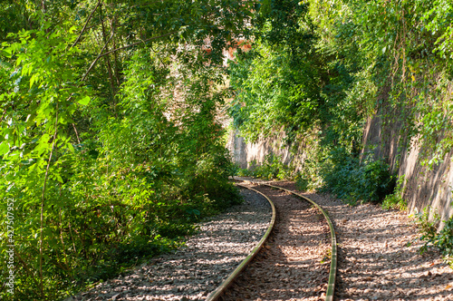 Part of the death railway, The railway train track runs along a hill through green forests and rivers.