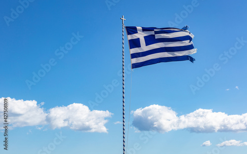 Greek flag waving against clear blue sky background. photo