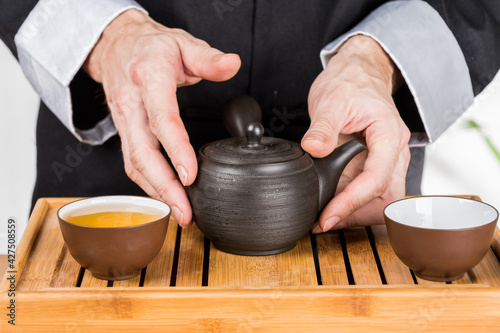 preparation of green loose tea in traditional Japanese ceramics