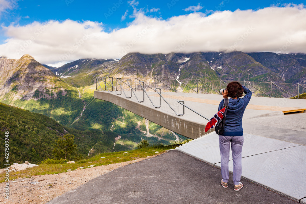 Tourist with camera on Utsikten viewpoint, Norway