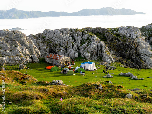 Camping in the Mayada de Tordín, in the Picos de Europa National Park: in the background the profile of the Sierra del Cuera (Asturias / . photo