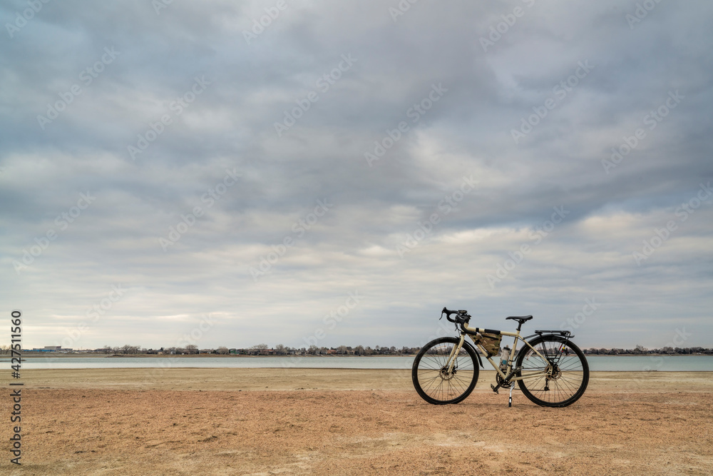 spring biking, touring or commuting - bicycle on a lake beach, Boyd Lake State Park in northern Colorado