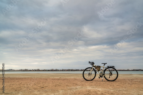 spring biking, touring or commuting - bicycle on a lake beach, Boyd Lake State Park in northern Colorado