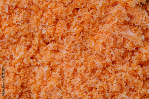 Shredded fresh carrots after juicer, close up, top view