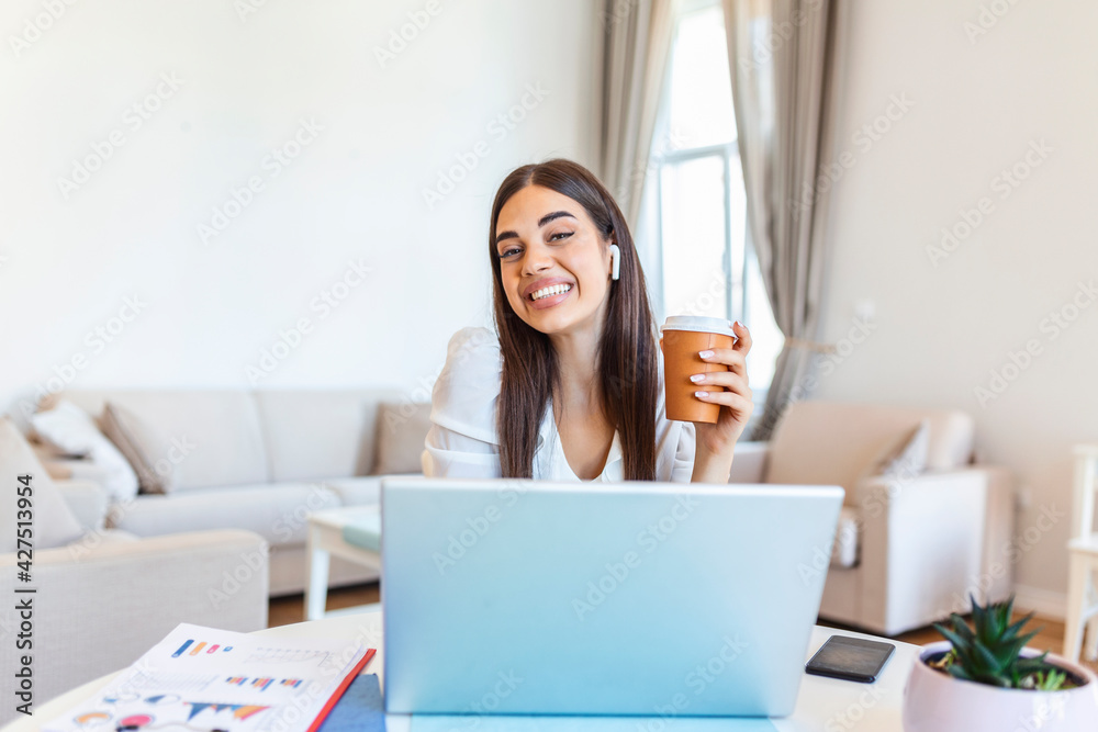 Excited young woman looking at camera, holding funny conversation with colleagues online, webcam view. Head shot of young woman with headphones laughing, having fun from home office. Excited young woman looking at camera, holding funny conversation with colleagues online, webcam view. Head shot of young woman with headphones laughing, having fun from home office.
