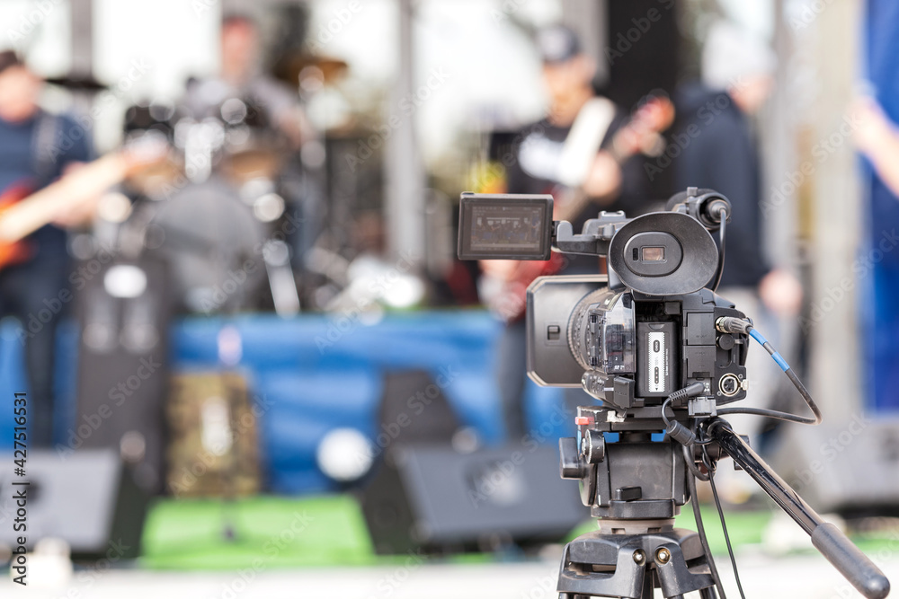 one camera in the open air filming a street concert one camera in the open air filming a street concert