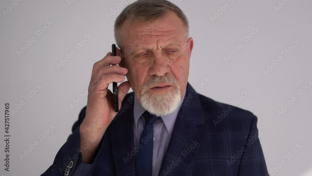 Experience old businessman talking to his family, wife, or his client on a mobile phone. Alone active man on the white background. Calmness, positive senior retired Concept Experience old businessman talking to his family, wife, or his client on a mobile phone. Alone active man on the white background. Calmness, positive senior retired Concept