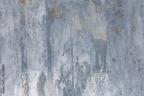 Gray dirty wall with old paint and chemical stains