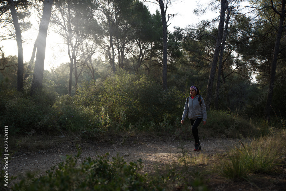 Woman with sportswear and backpack walking and exploring the mountains. Woman with sportswear and backpack walking and exploring the mountains.