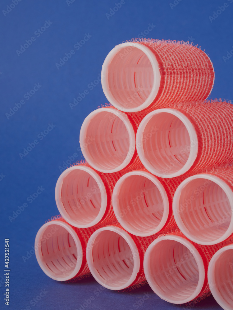 several red curlers on a blue background several red curlers on a blue background