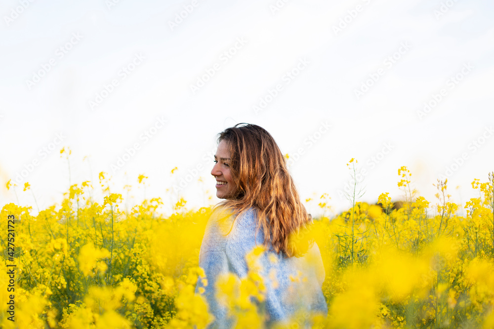 A happy girl in a meadow of yellow flowers A happy girl in a meadow of yellow flowers