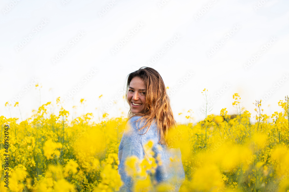 A happy girl in a meadow of yellow flowers A happy girl in a meadow of yellow flowers