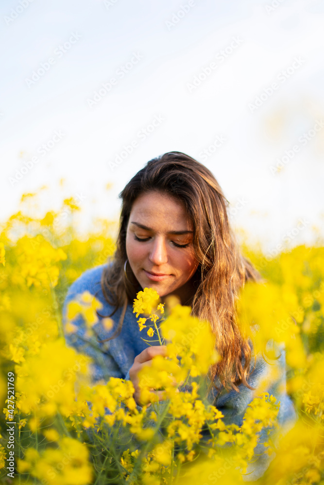 A happy girl in a meadow of yellow flowers A happy girl in a meadow of yellow flowers