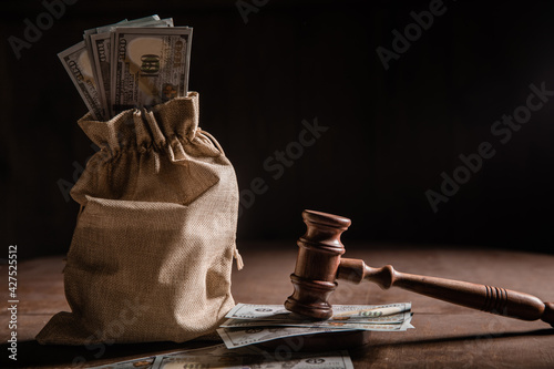 Fototapeta Dollar money bag and judge's gavel