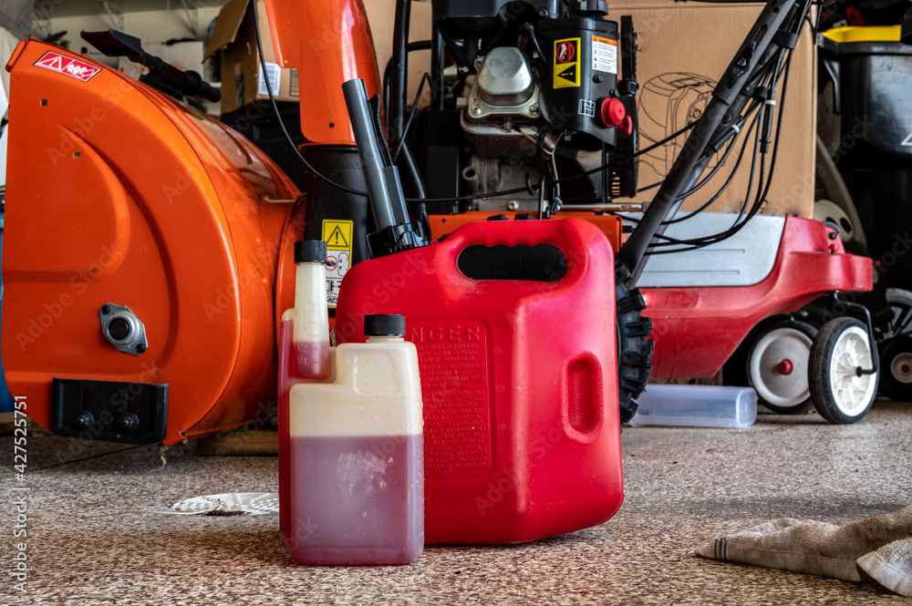 fuel stabilizer container for long term storage of gas in front of a portable canister and snow blower fuel stabilizer container for long term storage of gas in front of a portable canister and snow blower