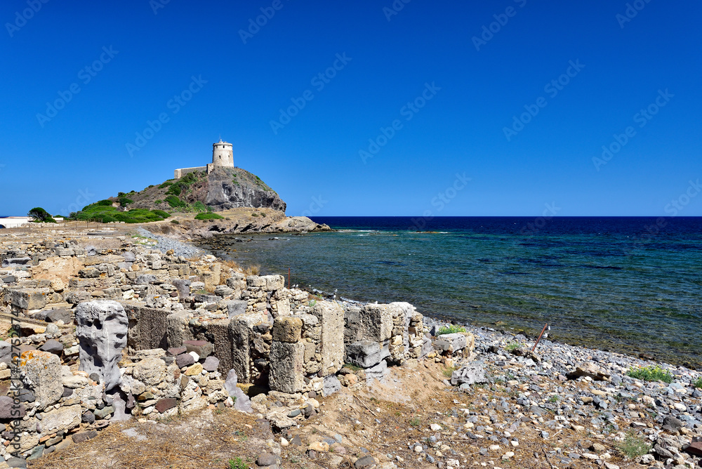 Excavations with an old tower in the background near the town of Nora on the island of Sardinia